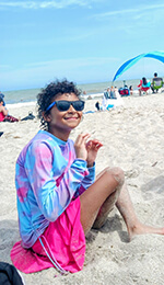 A child sitting on the beach.