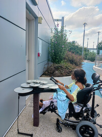 A child playing drums outside.