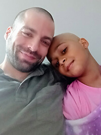 Two people smiling at the camera.