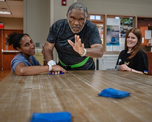 A patient tossing bean bags.
