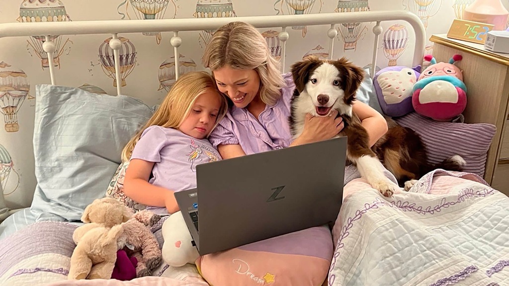 A woman and child looking at a laptop.