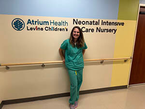 A medical professional standing in a hallway.