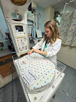 A medical professional using medical equipment.