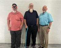 Three brothers standing in a row.
