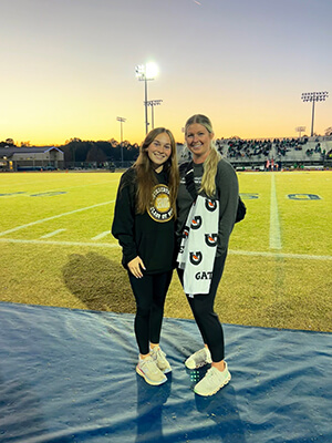 Two people posing on a track field.