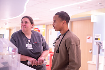 Two medical professionals looking at medical equipment.
