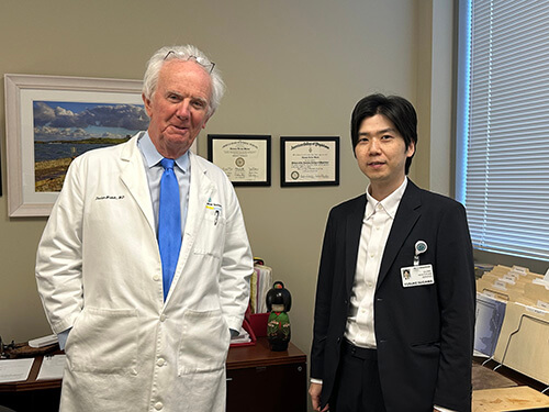 Two people standing side by side.