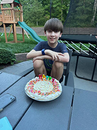 A child with a birthday cake.
