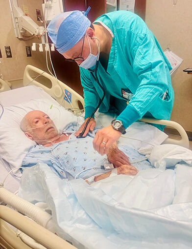 An old man receiving treatment at a hospital.