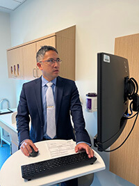 A medical professional looking at a computer screen.