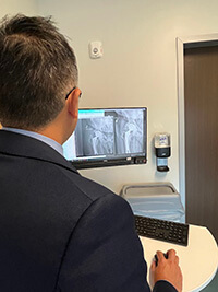 A medical professional looking at an X-ray.