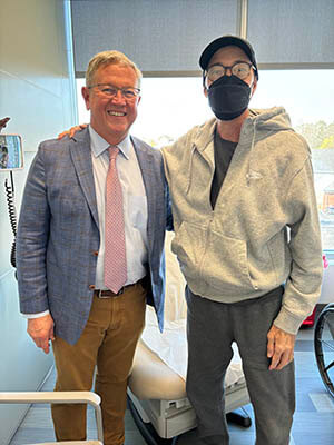 Two people standing side by side.