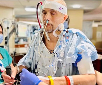 A man with medical equipment in a hospital.