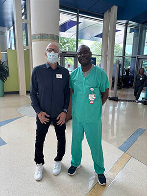A man and a medical professional standing side by side.