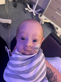 A baby looking at the camera.