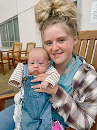A woman holding a baby.