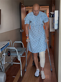 A man walking with crutches