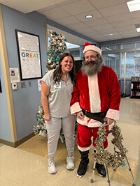 Santa and another person smiling at the camera.