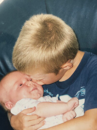 A child kissing a baby.