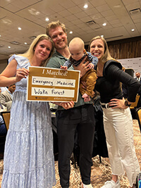 A group holding up a sign that reads "I Matched"