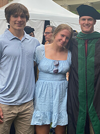 Three people standing side by side.