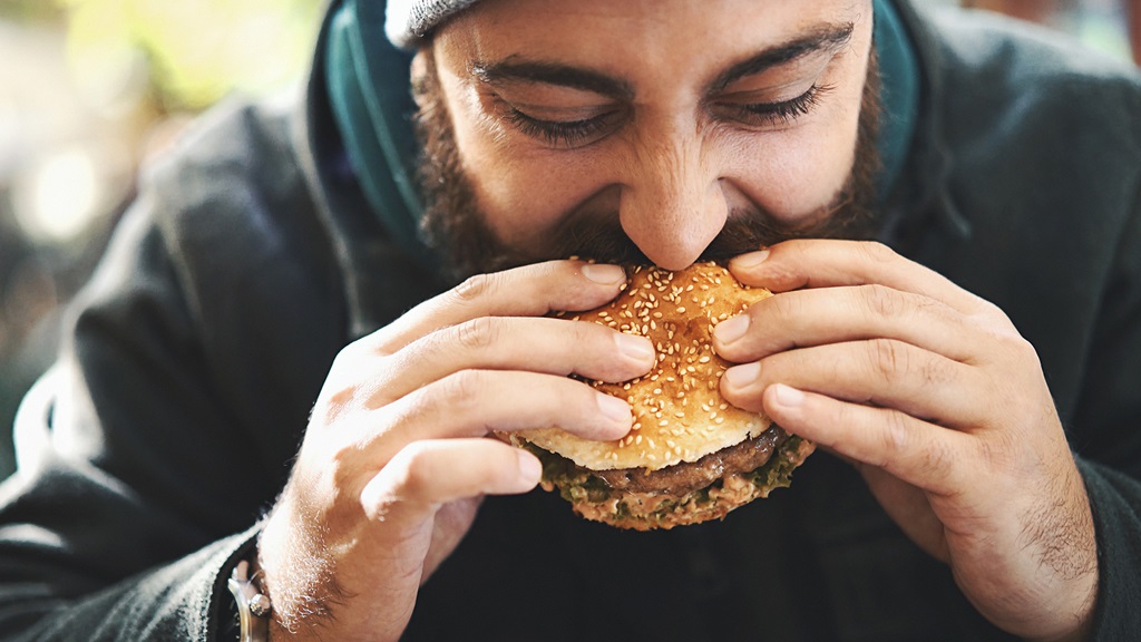 Man eating food quickly 