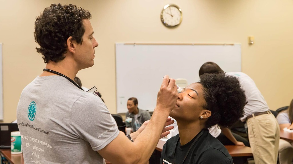 Atrium Health staff have volunteered their time to help make sure high school student-athletes are able to compete at their best. Hear what they have to say about Heart of a Champion Day and how the annual athletic screening event has become a part of our communities over the past 10 years. 