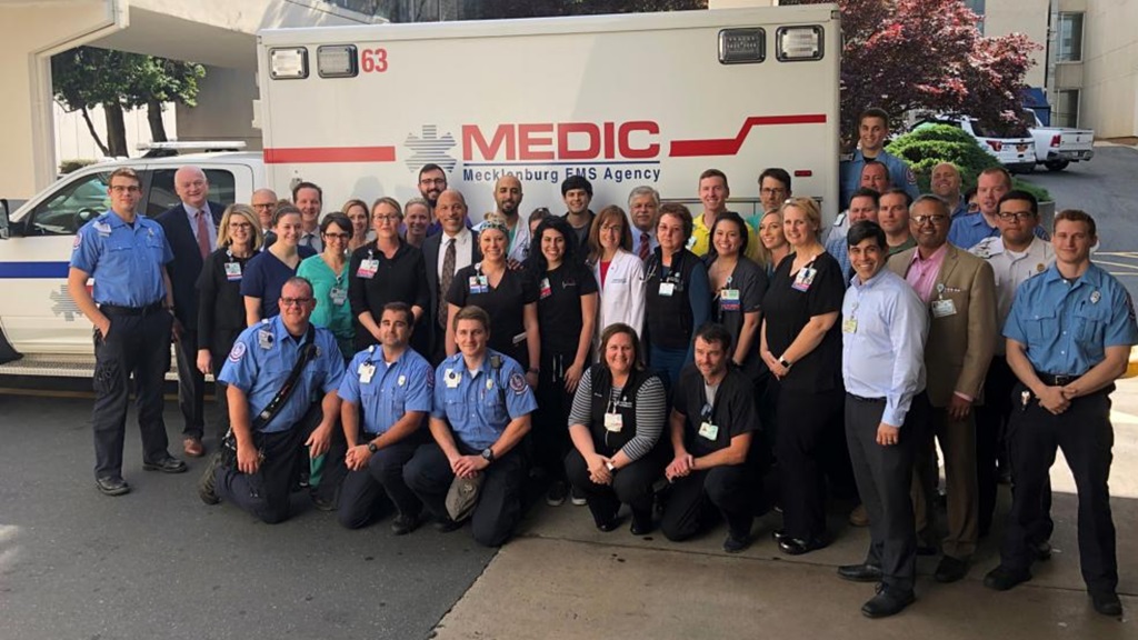 Eugene A. Woods, president and chief executive officer of Atrium Health, with the staff of Atrium Health's Carolinas Medical Center's Emergency Department and MEDIC. 