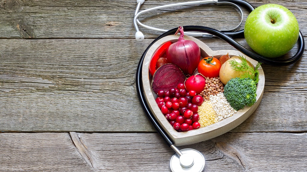 Healthy food arranged in the shape of a heart for heart month