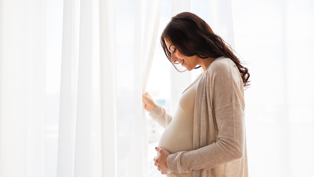 Pregnant woman holding her belly