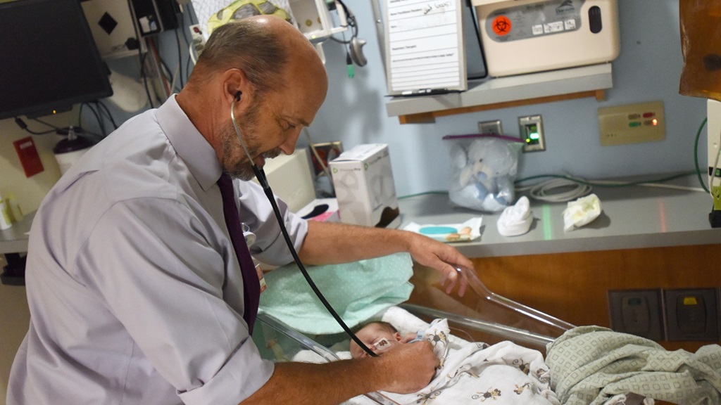 Dr Fisher tends to tiny baby in NICU