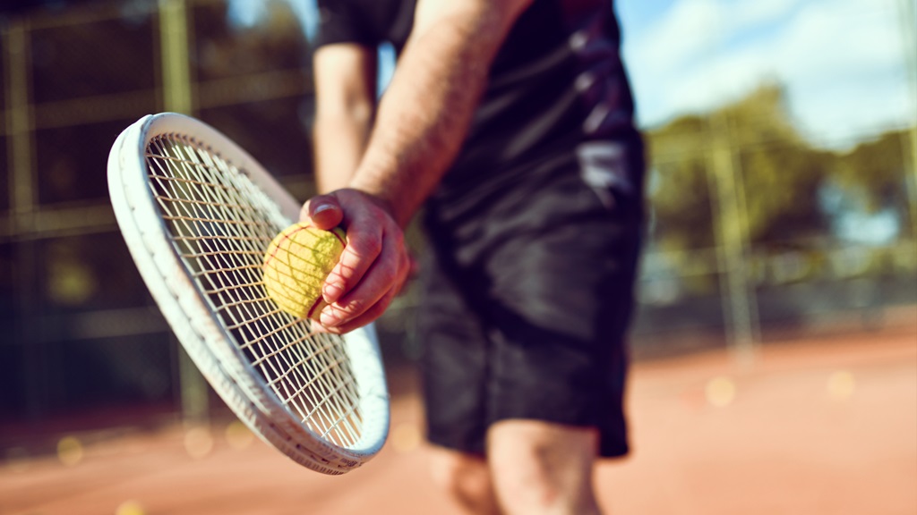 Tennis player getting ready to serve the ball