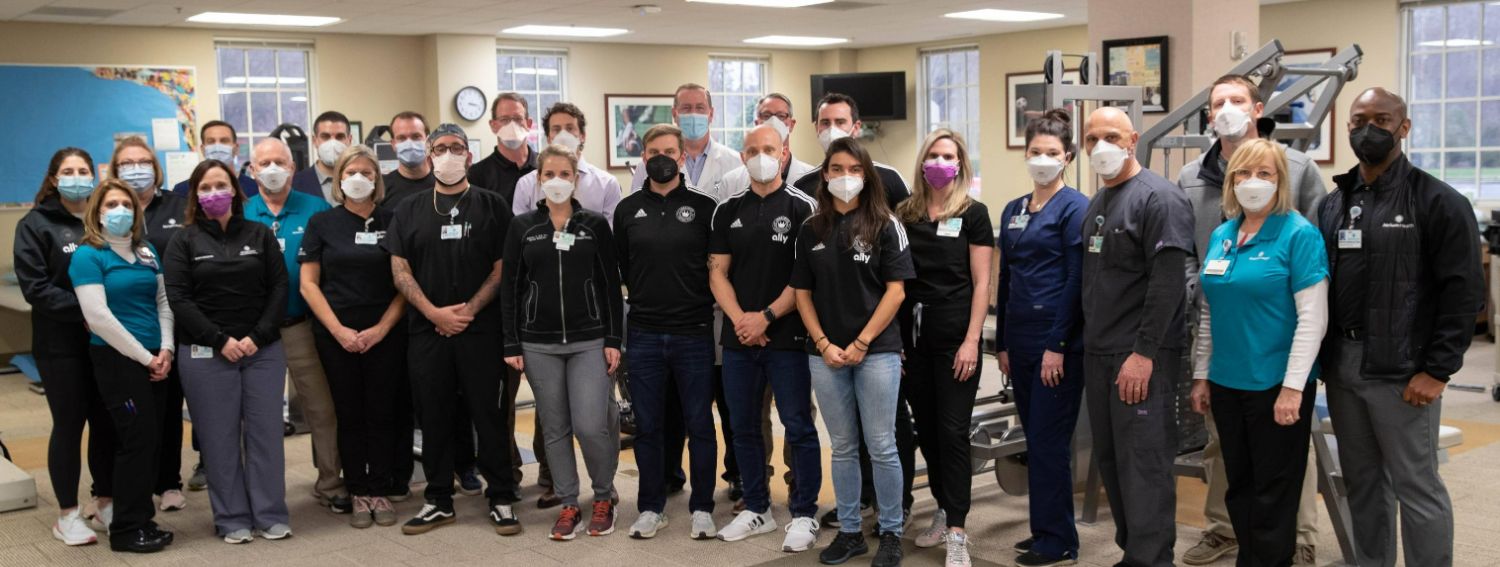 CFCAH Team standing in group inside hospital wearing masks.