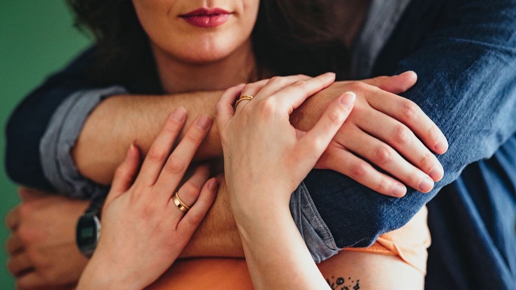 Man with arm around woman