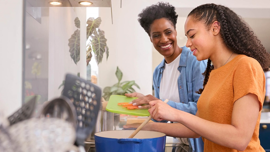Two people cooking food.