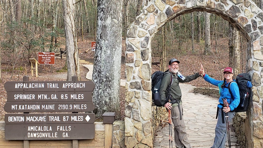 two people standing at start of a trail 