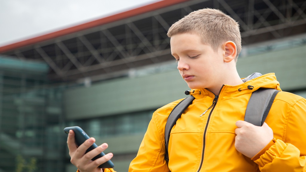 Teenage boy looking at his phone 