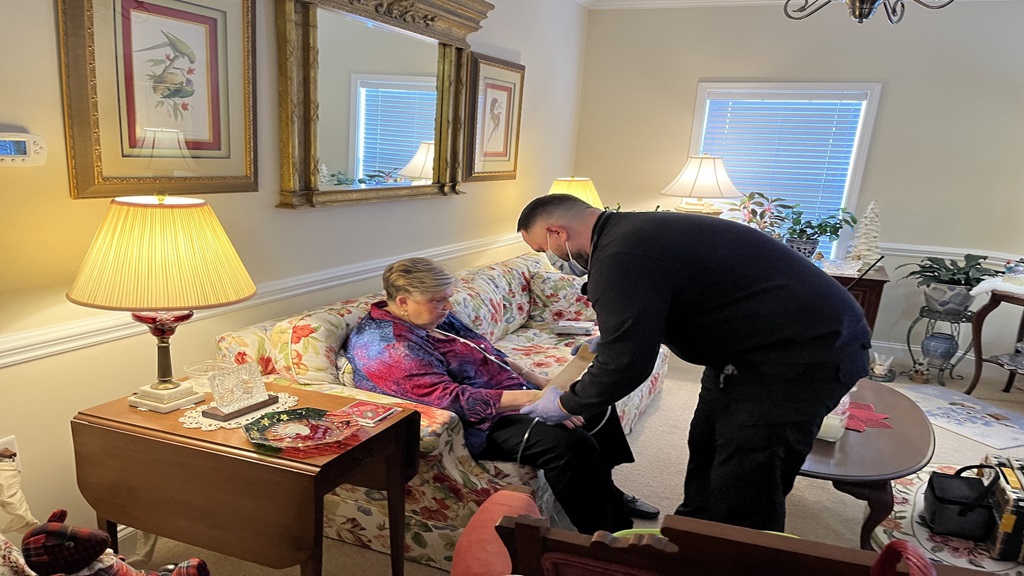 Atrium Health’s Mobile Integrated Health team assisting a woman at home 