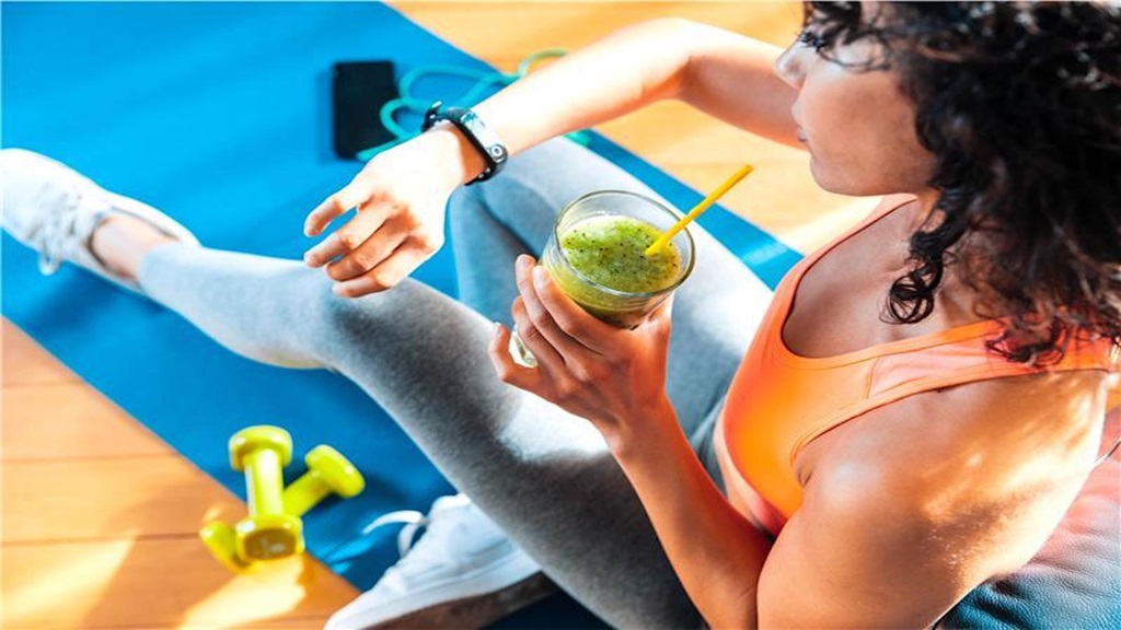 Woman checking watch at gym