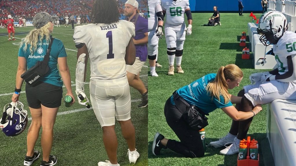 Athletic Trainer looking at football players knee 