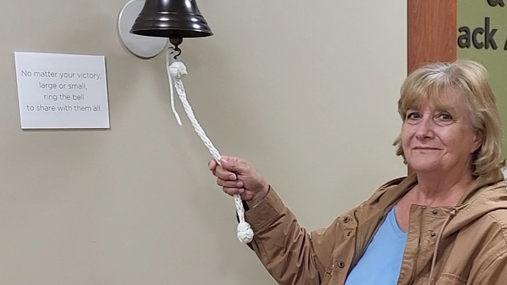 Nancy Mason ringing the bell