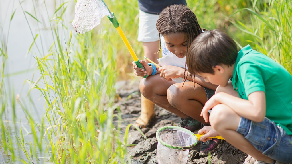 Two kids fishing on a hot summer day