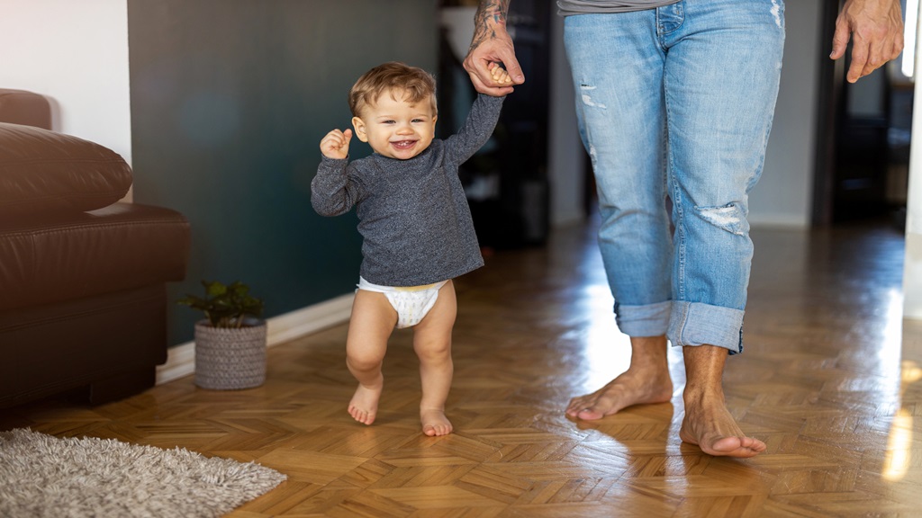 toddler holding parents hand