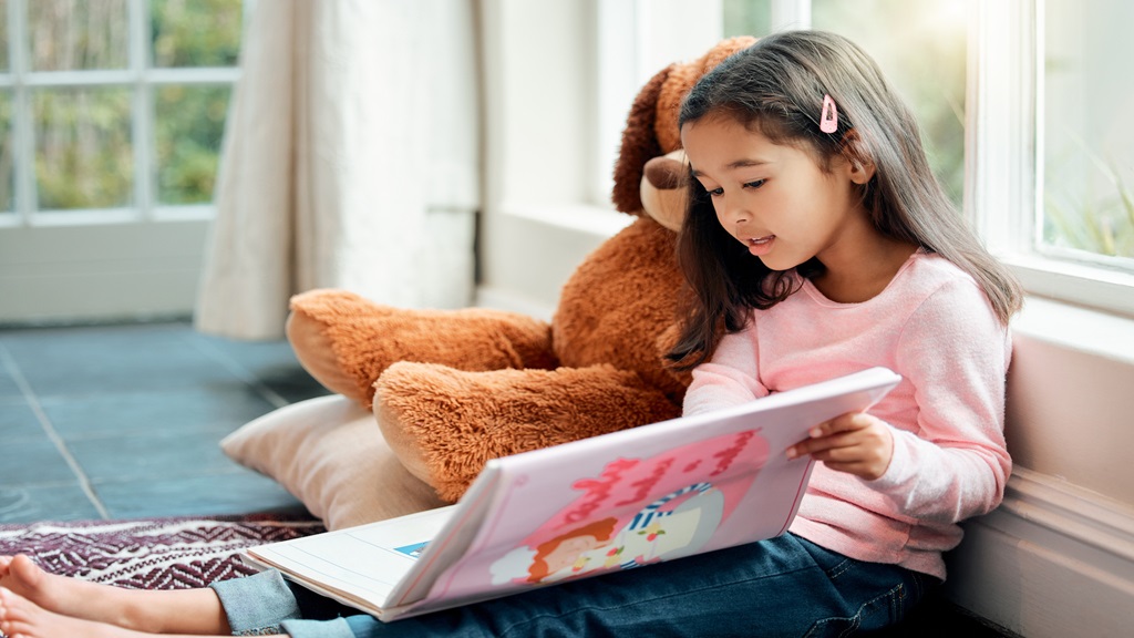 Little girl reading a book