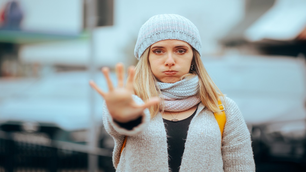 woman standing with her hand out and fingers flared