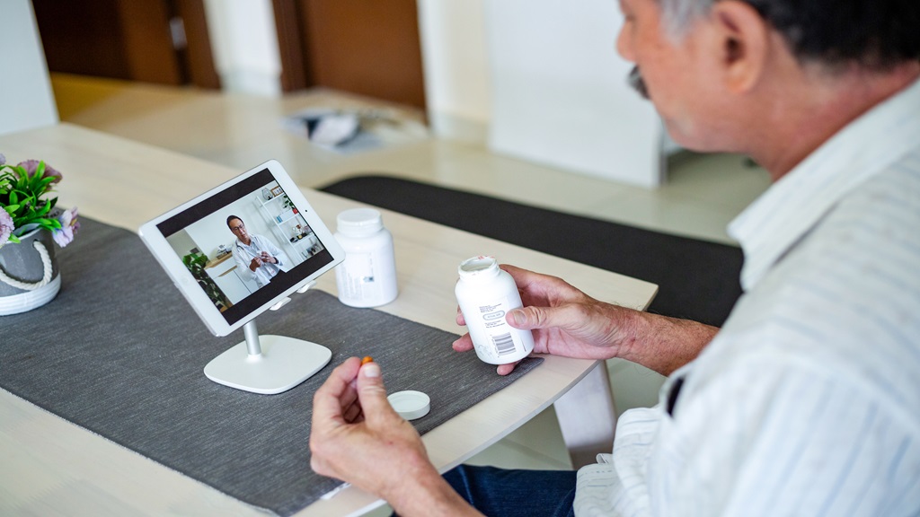 Man meeting with doctor on tablet