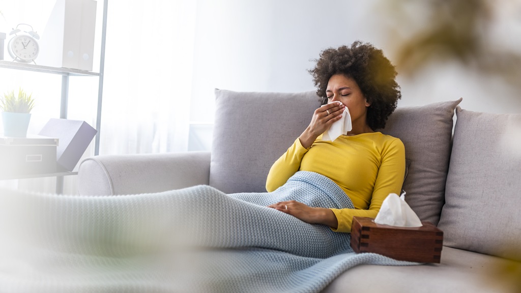 Person sitting on couch sick