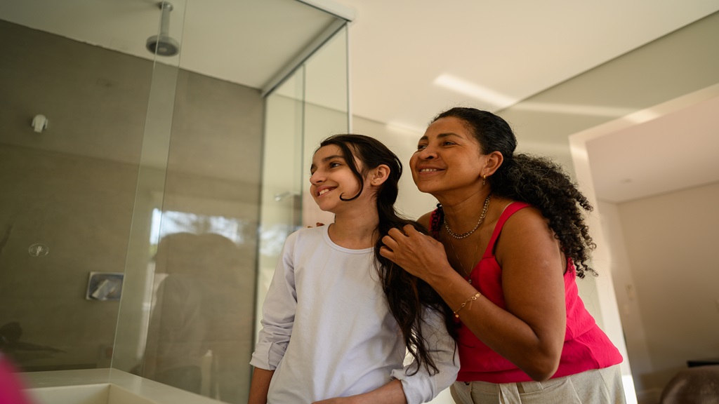 Mom and child standing in front of mirror 