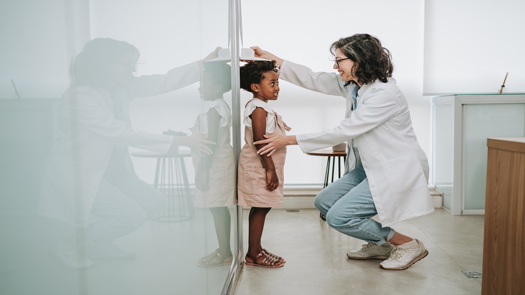 Childs height being measured at the doctors