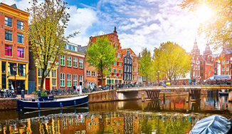 A group of buildings beside a lake.